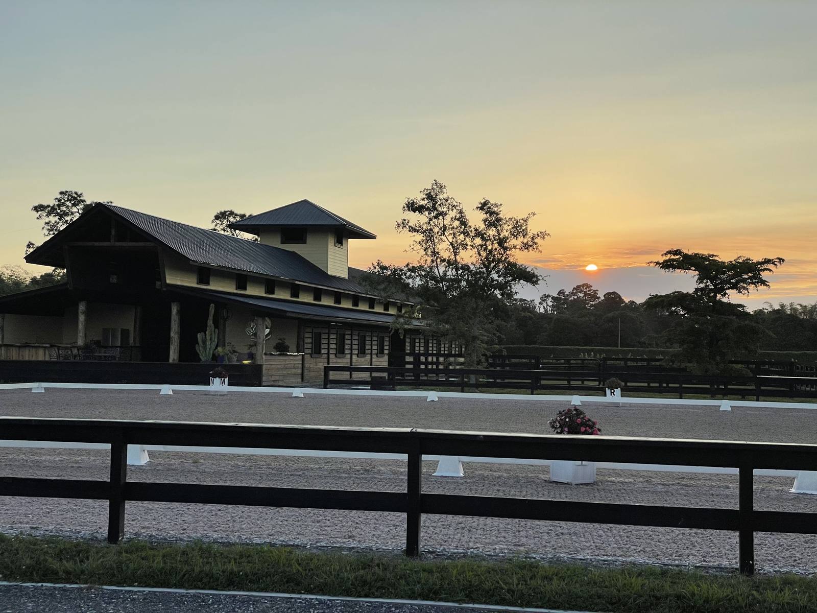 The arena and barn at sunset
