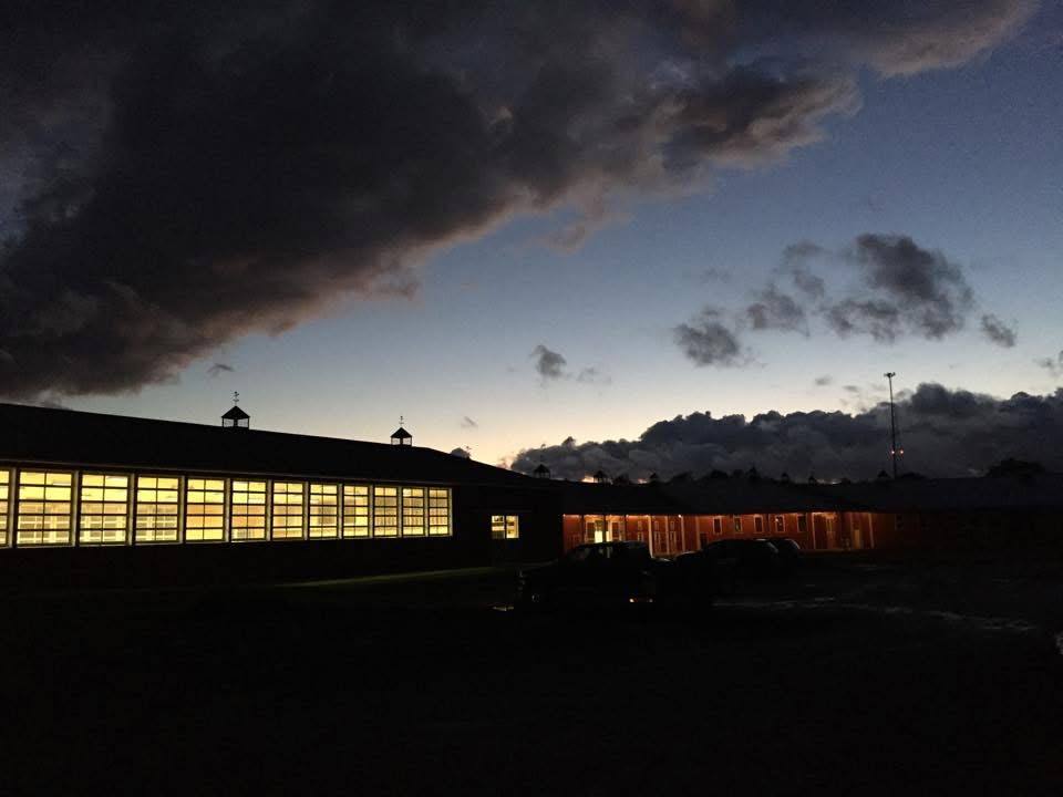 Storm light breaking over the lit barn
