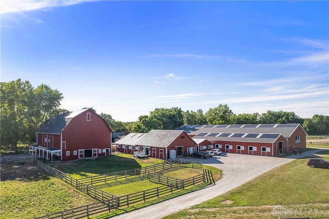 The Heritage Stables barns under a summer sky