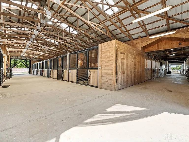 A matted stall aisle inside the barn