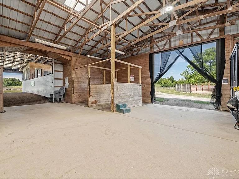 Inside the barn, with doors open to the fields